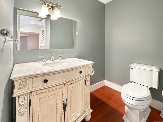 14 W Mystic Ave, Groton, CT 06355 - bathroom featuring toilet, vanity, wood finished floors, and baseboards
