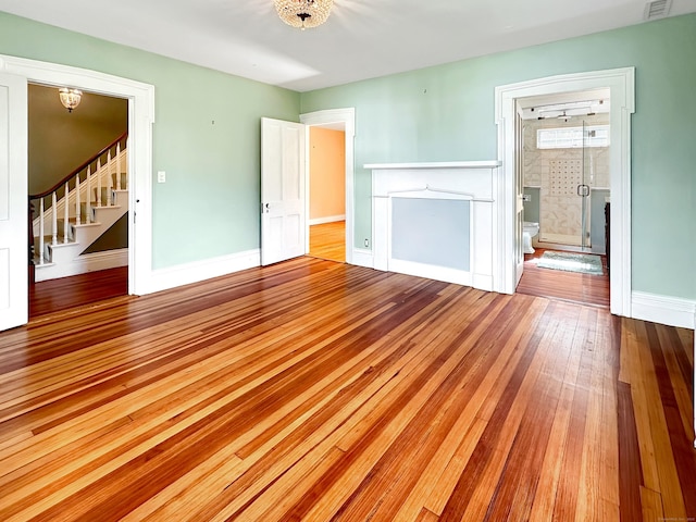 14 W Mystic Ave, Groton, CT 06355 - unfurnished living room featuring hardwood / wood-style flooring, stairway, and baseboards