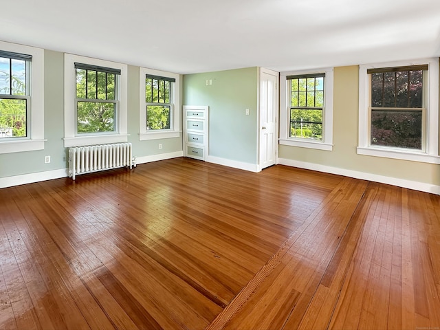 14 W Mystic Ave, Groton, CT 06355 - unfurnished room featuring radiator, hardwood / wood-style floors, baseboards, and plenty of natural light