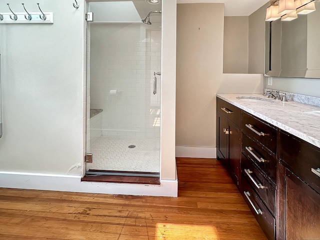 14 W Mystic Ave, Groton, CT 06355 - full bathroom with a shower stall, wood finished floors, baseboards, and vanity