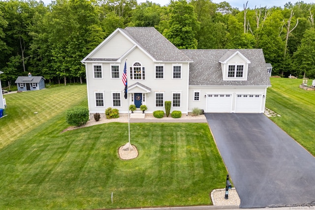 9 Tall Wood Dr, East Hampton, CT 06424 - colonial inspired home with asphalt driveway, a shingled roof, a front lawn, and an attached garage