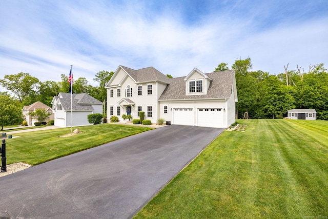 9 Tall Wood Dr, East Hampton, CT 06424 - colonial-style house featuring asphalt driveway, a front lawn, and a shingled roof