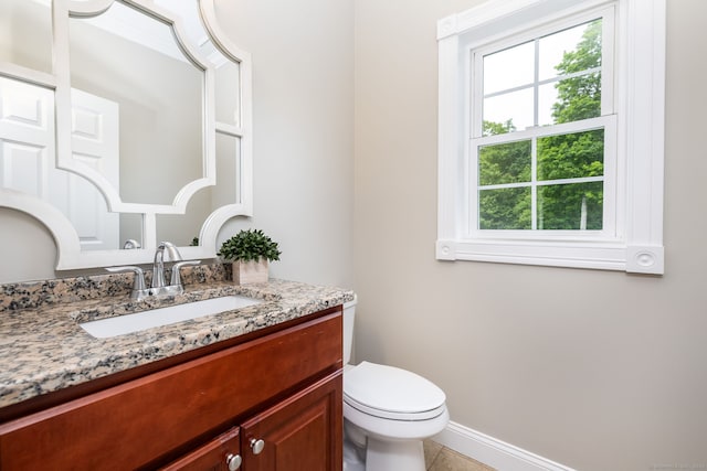 9 Tall Wood Dr, East Hampton, CT 06424 - half bath featuring plenty of natural light, vanity, toilet, and tile patterned flooring