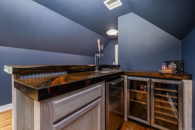 9 Tall Wood Dr, East Hampton, CT 06424 - indoor dry bar featuring beverage cooler, light wood-style flooring, and vaulted ceiling