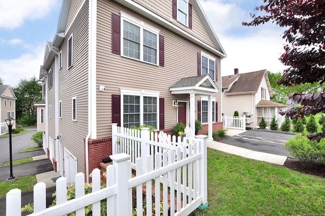 35 Ringgold St Unit 401, West Hartford, CT 06119 - view of front of property with a fenced front yard and brick siding