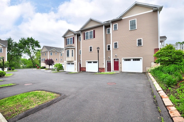 35 Ringgold St Unit 401, West Hartford, CT 06119 - rear view of house with a garage, a residential view, and asphalt driveway