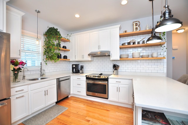 35 Ringgold St Unit 401, West Hartford, CT 06119 - kitchen with open shelves, appliances with stainless steel finishes, under cabinet range hood, a sink, and backsplash