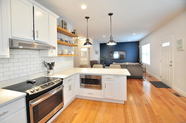 35 Ringgold St Unit 401, West Hartford, CT 06119 - kitchen featuring appliances with stainless steel finishes, under cabinet range hood, open shelves, a peninsula, and light countertops