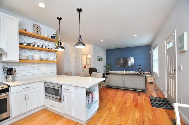 35 Ringgold St Unit 401, West Hartford, CT 06119 - kitchen featuring open shelves, stainless steel appliances, decorative backsplash, white cabinets, and light wood finished floors