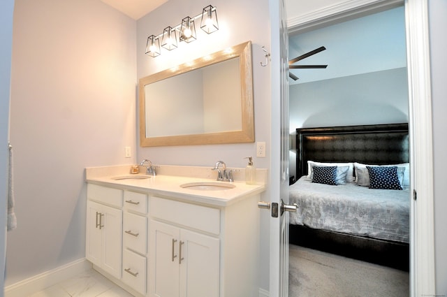 35 Ringgold St Unit 401, West Hartford, CT 06119 - full bath with double vanity, baseboards, connected bathroom, marble finish floors, and a ceiling fan