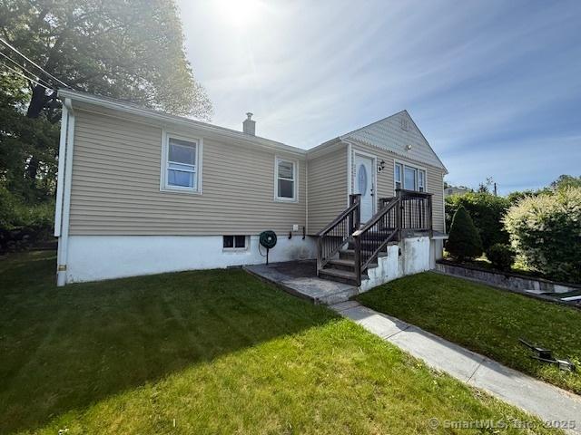 332 Lakeside Blvd E, Waterbury, CT 06708 - rear view of property featuring a lawn