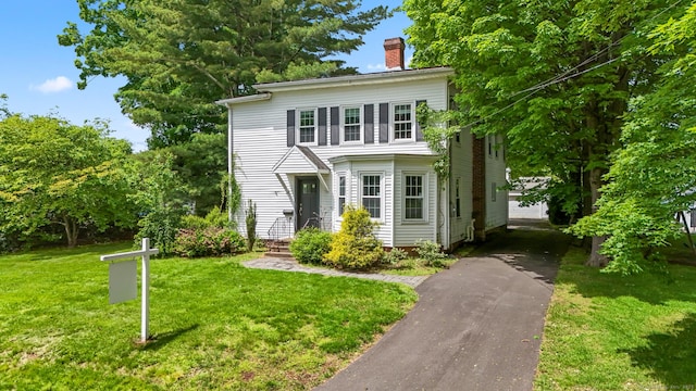 27 Maple St, Berlin, CT 06037 - view of front of property with a chimney, a front lawn, and driveway