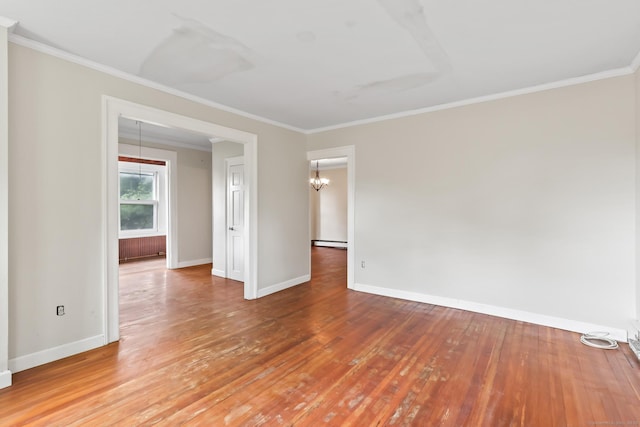 27 Maple St, Berlin, CT 06037 - spare room with ornamental molding, baseboards, wood finished floors, baseboard heating, and a chandelier