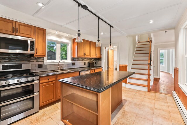 27 Maple St, Berlin, CT 06037 - kitchen featuring stainless steel appliances, a baseboard heating unit, a sink, decorative backsplash, and a kitchen island