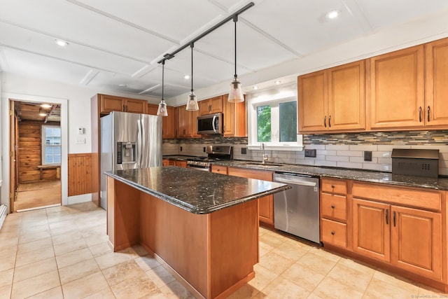 27 Maple St, Berlin, CT 06037 - kitchen with stainless steel appliances, a sink, a kitchen island, dark stone counters, and brown cabinetry
