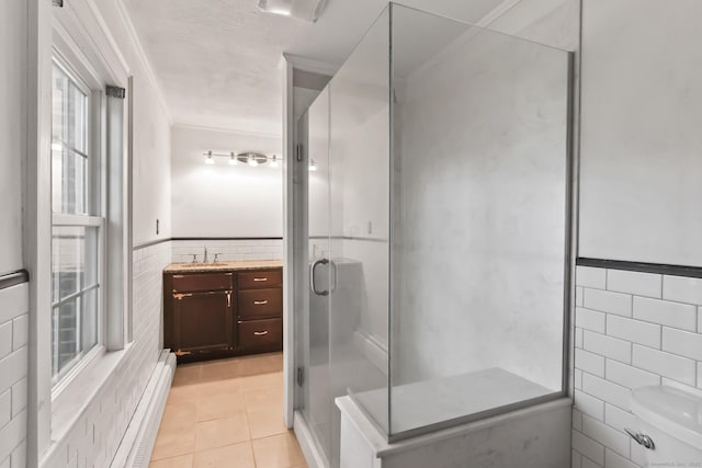27 Maple St, Berlin, CT 06037 - bathroom featuring tile walls, a stall shower, vanity, tile patterned floors, and a baseboard radiator