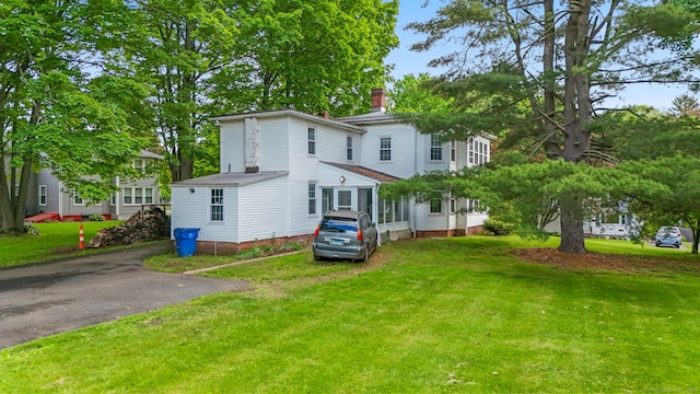 27 Maple St, Berlin, CT 06037 - view of front facade with a front yard and a chimney