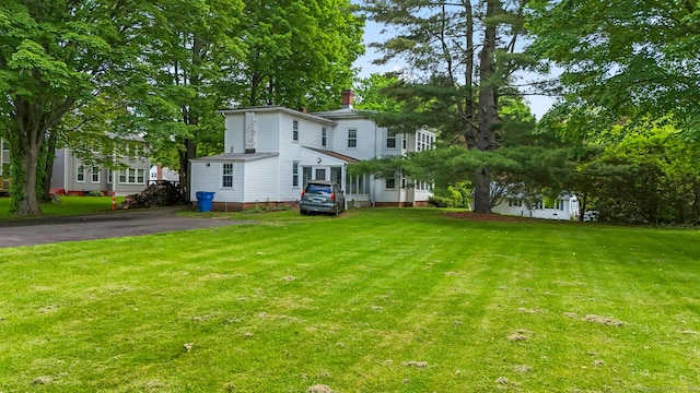 27 Maple St, Berlin, CT 06037 - view of front facade featuring a front yard and a chimney