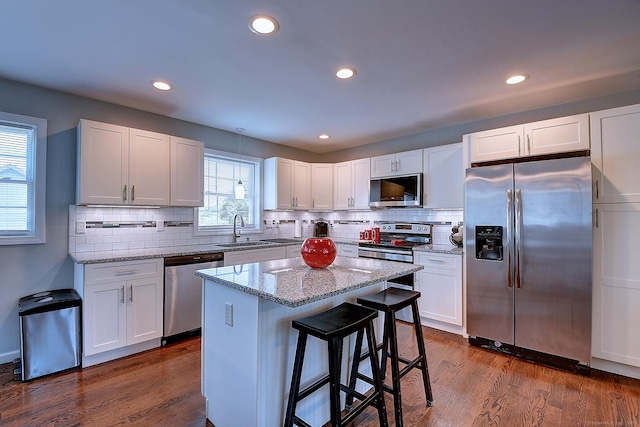 105 Scott St, Naugatuck, CT 06770 - kitchen featuring appliances with stainless steel finishes, a sink, white cabinetry, backsplash, and recessed lighting