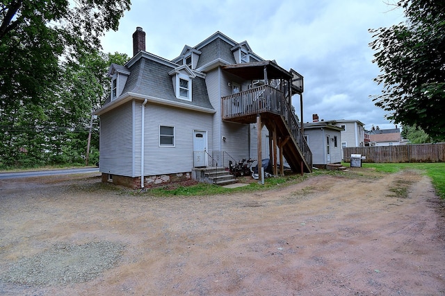 34 Woodbridge St, Manchester, CT 06042 - rear view of house featuring a balcony, mansard roof, and a chimney