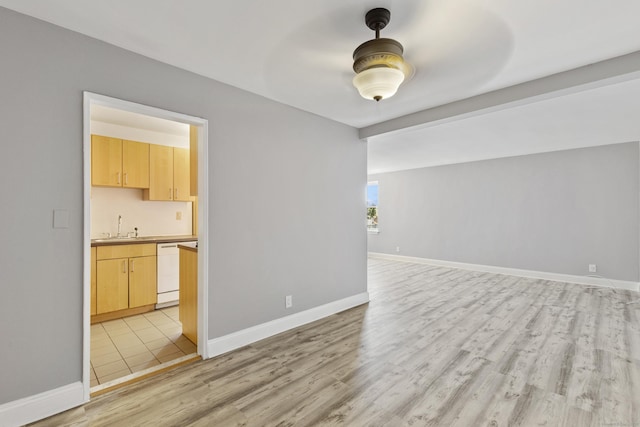 39 Glenbrook Rd Apt 2A, Stamford, CT 06902 - empty room with light wood-style floors, bar with sink, and baseboards