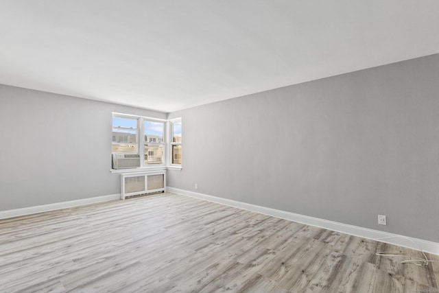 39 Glenbrook Rd Apt 2A, Stamford, CT 06902 - unfurnished room featuring light wood-type flooring, baseboards, radiator, and cooling unit