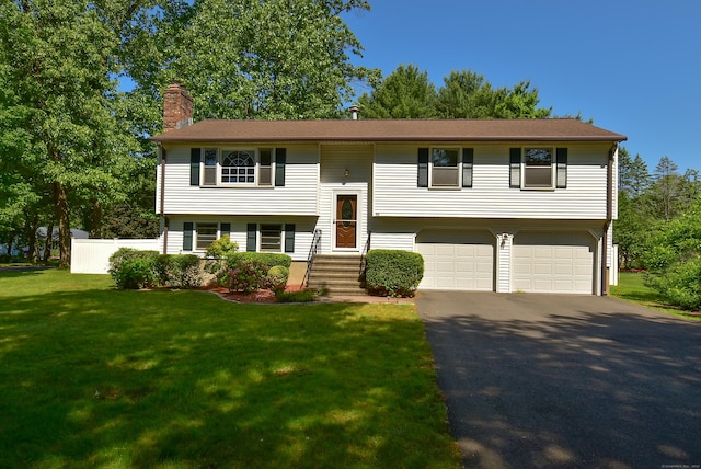 169 Brookfield St, South Windsor, CT 06074 - split foyer home featuring a chimney, a garage, and asphalt driveway