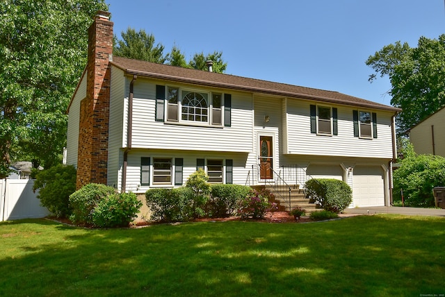 169 Brookfield St, South Windsor, CT 06074 - bi-level home with a chimney, concrete driveway, and an attached garage