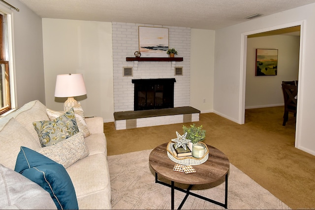169 Brookfield St, South Windsor, CT 06074 - living room featuring carpet floors, a fireplace, baseboards, and a textured ceiling