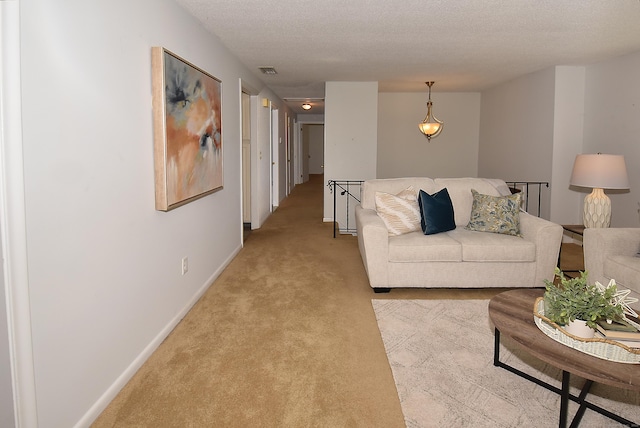 169 Brookfield St, South Windsor, CT 06074 - living area featuring light carpet, baseboards, and a textured ceiling
