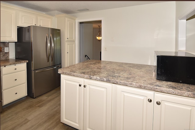 169 Brookfield St, South Windsor, CT 06074 - kitchen featuring freestanding refrigerator, black microwave, and wood finished floors