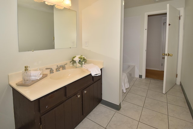 169 Brookfield St, South Windsor, CT 06074 - bathroom with vanity, baseboards, a bath, and tile patterned floors