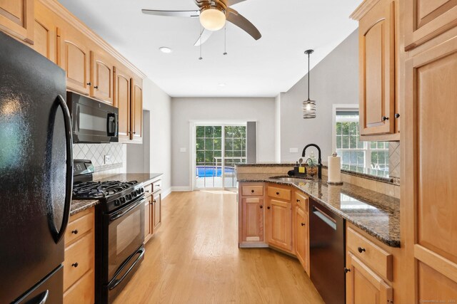 584 Meriden Ave Unit 1, Southington, CT 06489 - kitchen with black appliances, a sink, light wood-style floors, backsplash, and a peninsula