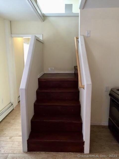 41 Lisbon St, Hartford, CT 06106 - stairs with a baseboard heating unit and wood finished floors