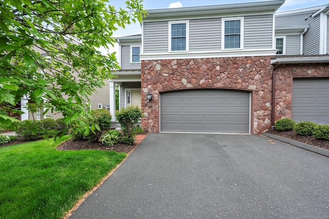 6 Mill Pond Ln Unit A, Simsbury, CT 06070 - view of front facade featuring stone siding, asphalt driveway, a garage, and a front yard