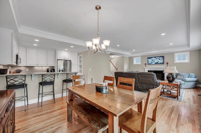 6 Mill Pond Ln Unit A, Simsbury, CT 06070 - dining room featuring a raised ceiling, light wood-type flooring, recessed lighting, stairs, and a chandelier