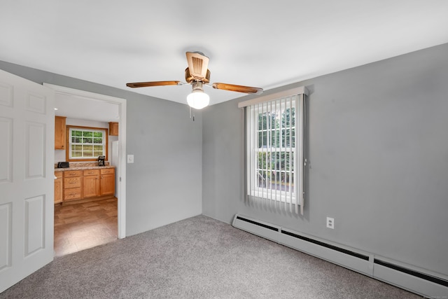 40 W View Dr, Enfield, CT 06082 - carpeted empty room with a baseboard heating unit and a ceiling fan
