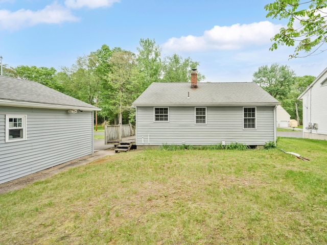 40 W View Dr, Enfield, CT 06082 - rear view of house featuring a chimney, a wooden deck, and a lawn