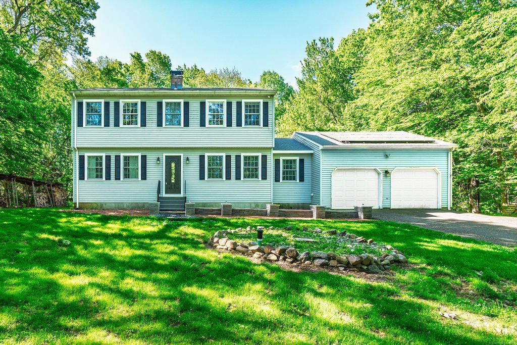 27 Porter Rd, Wolcott, CT 06716 - colonial home with a garage, driveway, a chimney, and entry steps
