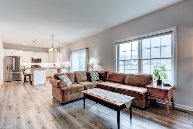 2 Linden Ct, Southington, CT 06489 - living area with plenty of natural light, light wood-style floors, and recessed lighting