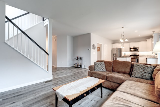 2 Linden Ct, Southington, CT 06489 - living area with light wood-style floors, baseboards, stairs, a chandelier, and recessed lighting