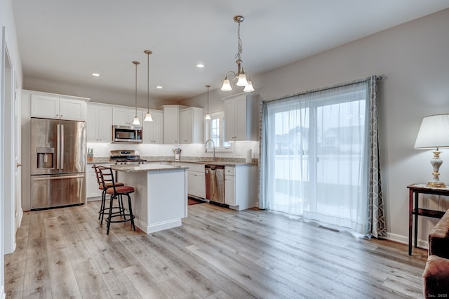 2 Linden Ct, Southington, CT 06489 - kitchen with appliances with stainless steel finishes, a center island, white cabinetry, light wood-style floors, and recessed lighting