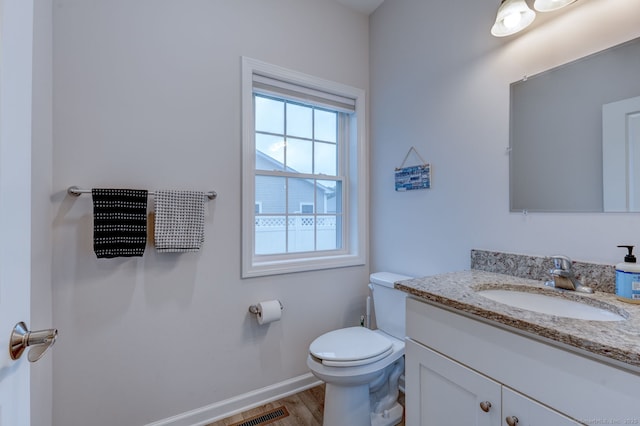2 Linden Ct, Southington, CT 06489 - half bath with vanity, toilet, healthy amount of natural light, and baseboards