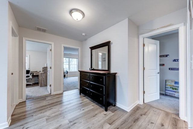 2 Linden Ct, Southington, CT 06489 - corridor with light wood finished floors, a desk, and baseboards