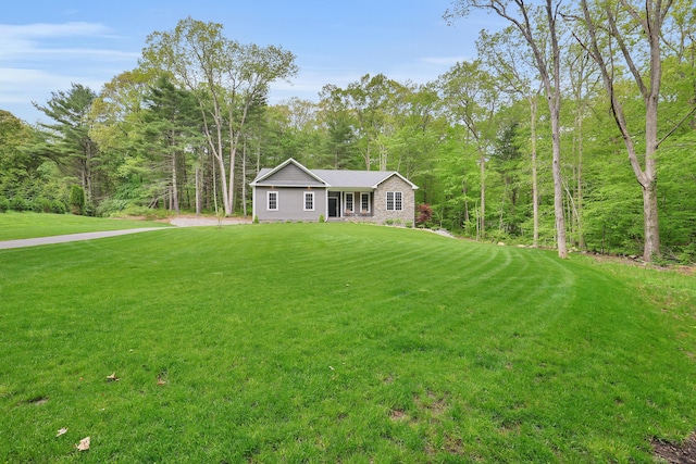 17 Paper Mill Rd, Marlborough, CT 06447 - view of front of house with a front yard, stone siding, and a forest view