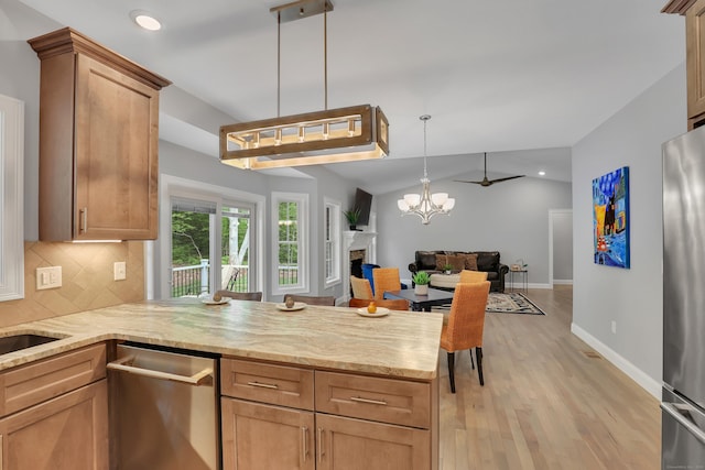 17 Paper Mill Rd, Marlborough, CT 06447 - kitchen with stainless steel appliances, open floor plan, a peninsula, light wood-style flooring, and backsplash