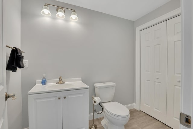 17 Paper Mill Rd, Marlborough, CT 06447 - bathroom with a closet, toilet, vanity, wood finished floors, and baseboards