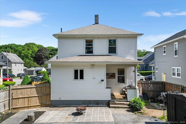 76 Geer Ave, Norwich, CT 06360 - rear view of house featuring a patio area, an outdoor fire pit, and roof with shingles