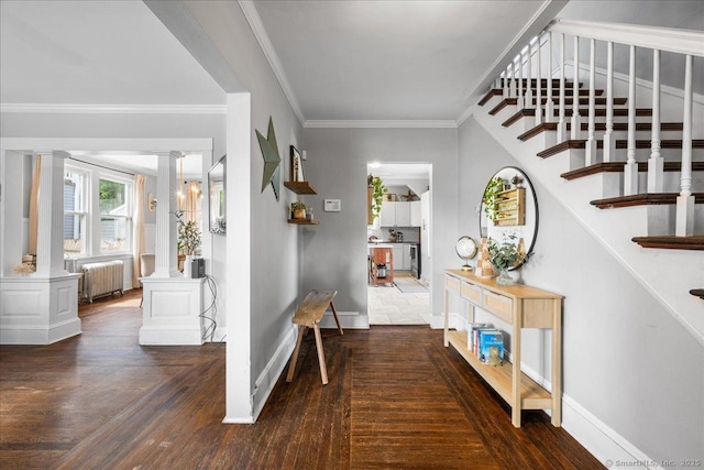 76 Geer Ave, Norwich, CT 06360 - entryway featuring radiator, ornate columns, stairway, wood finished floors, and baseboards