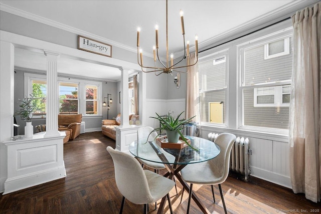 76 Geer Ave, Norwich, CT 06360 - dining area with ornate columns, ornamental molding, radiator, a chandelier, and wood finished floors